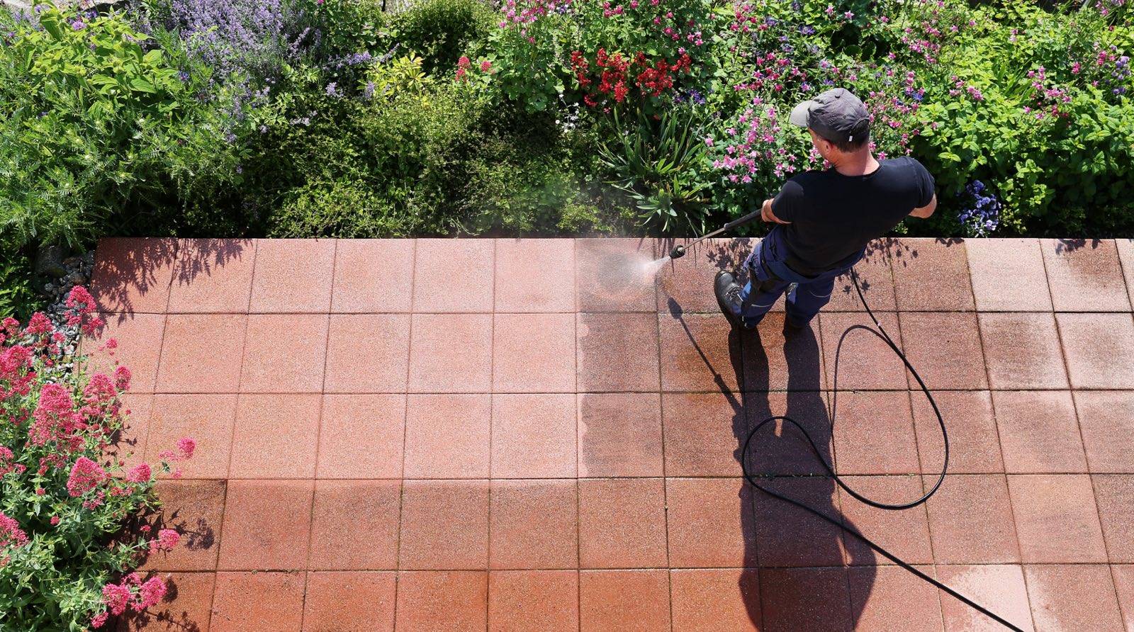 Pressure washing a paved garden patio in the Adelaide Hills